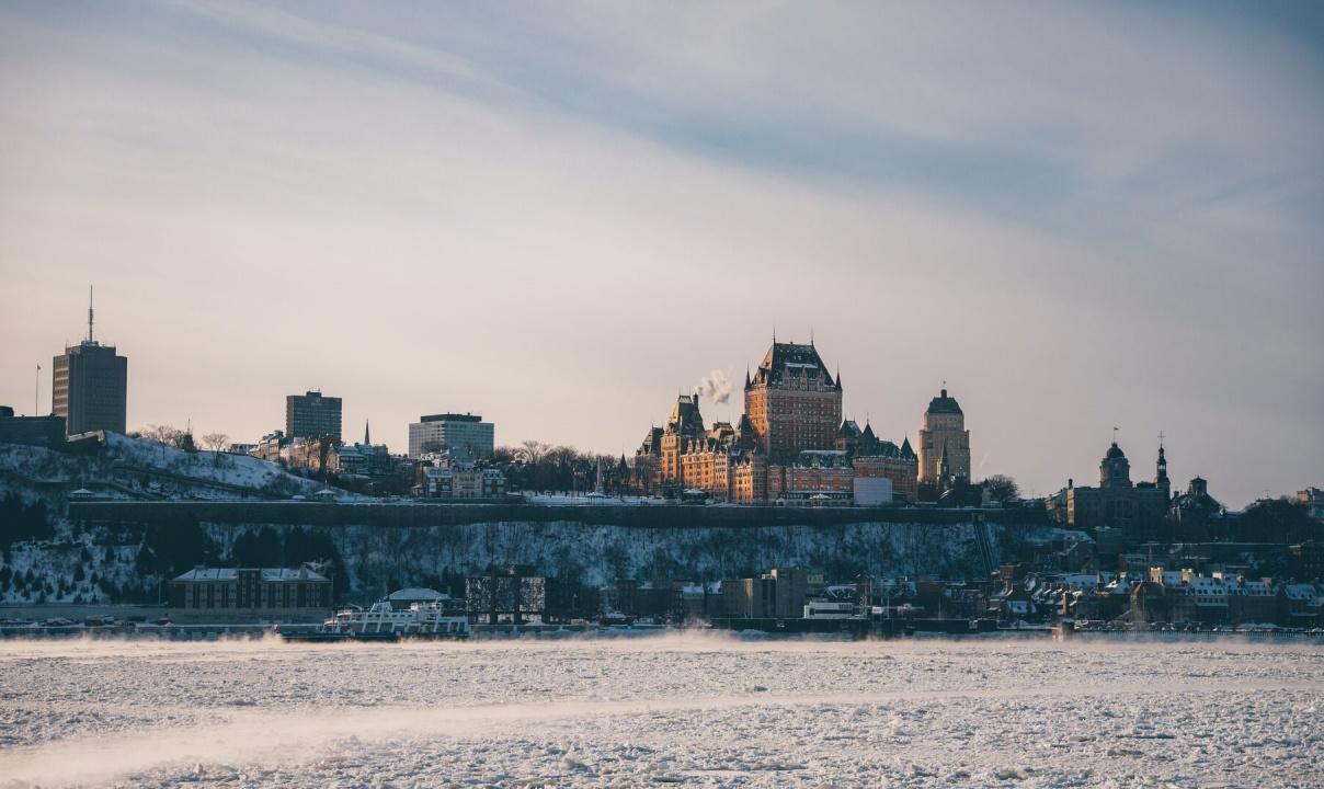 A view of downtown Quebec City with a frosty river in the foreground.