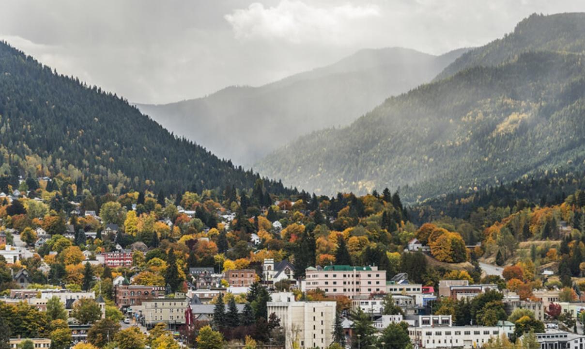 An autumn view of downtown Nelson, BC with mountains in the background.