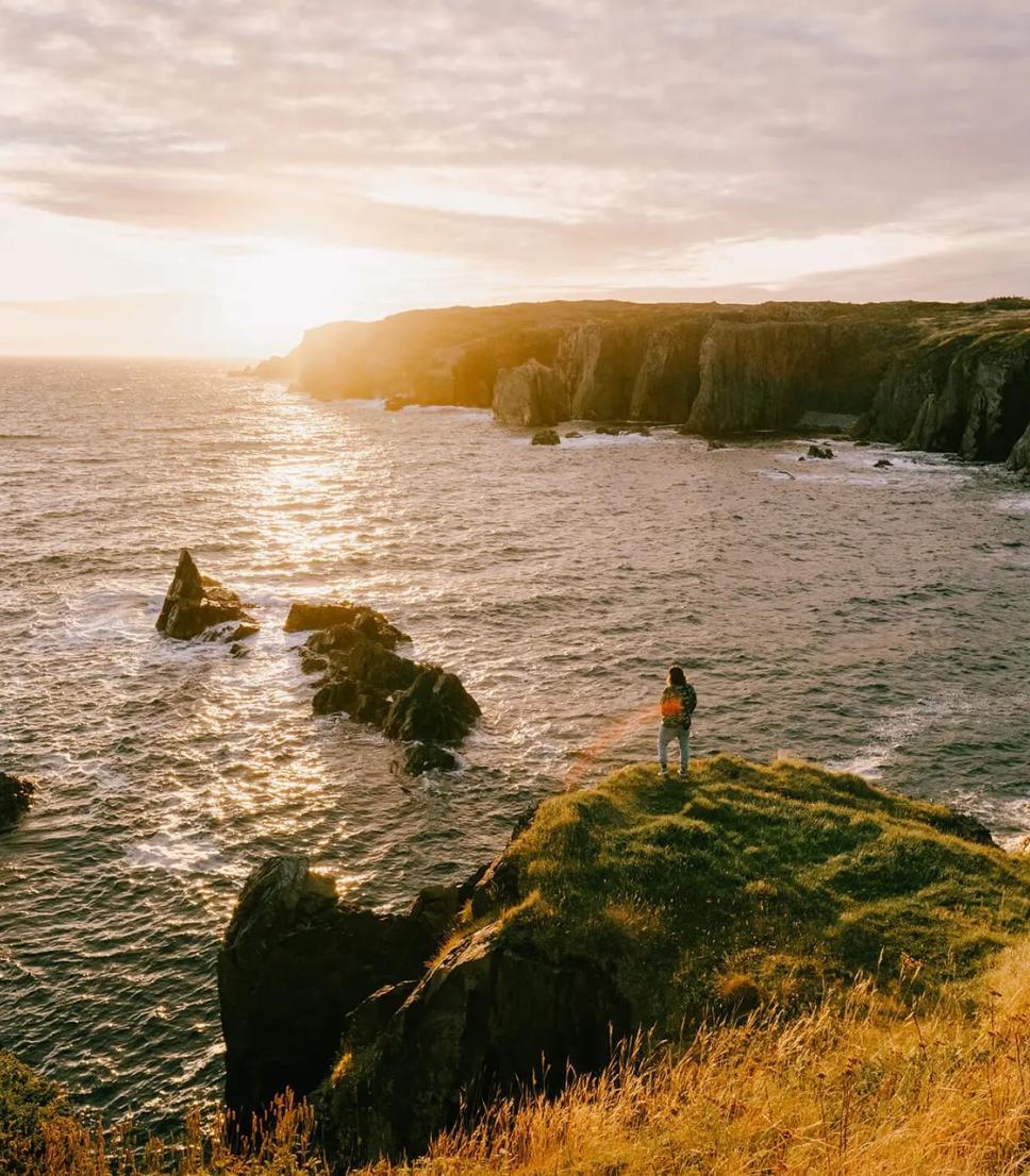 A jagged rock face on the edge of the ocean