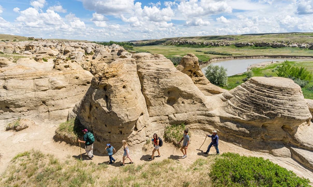 Six people hiking through the hoodoos.