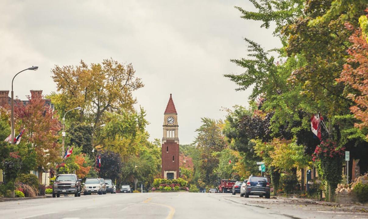 A clock tower at the end of a tree-lined street in Niagara-on-the-Lake, Ontario.