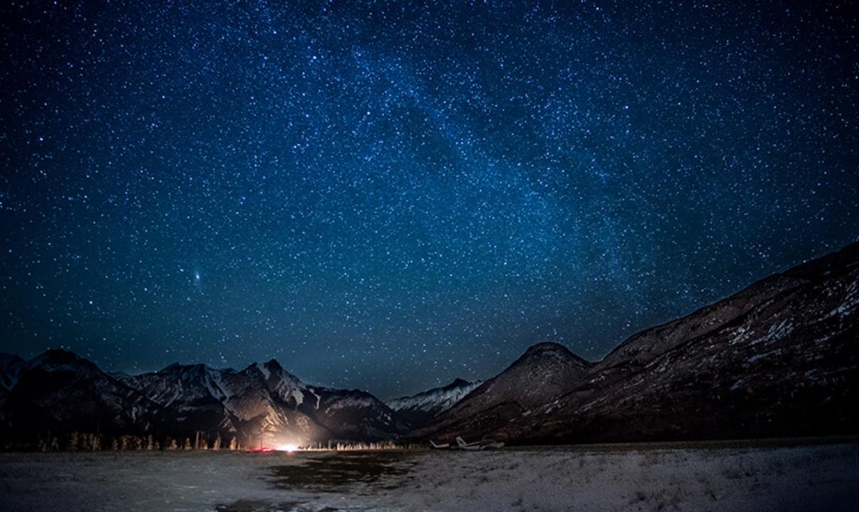 A winter night with a star-filled sky.